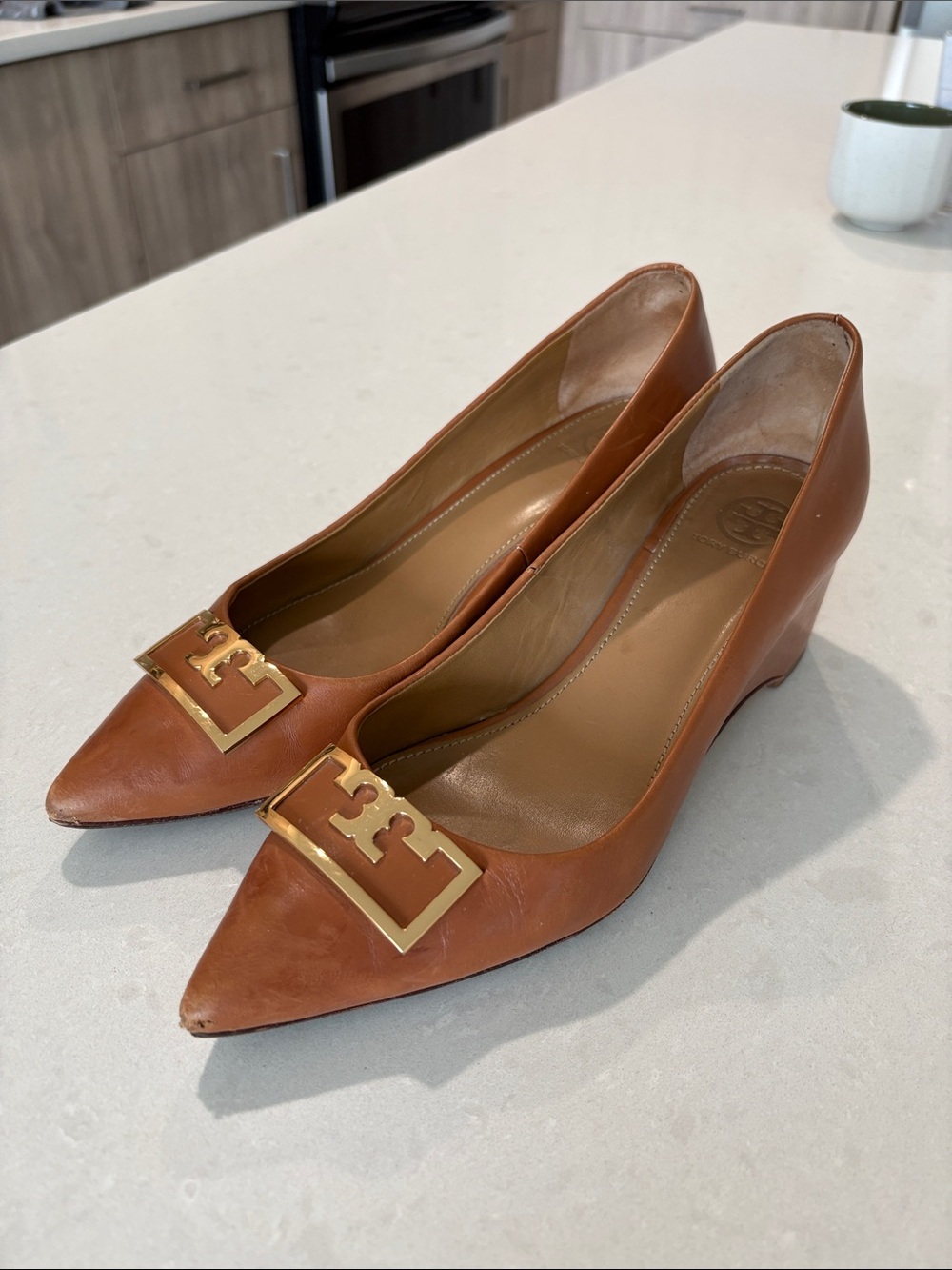 Tory Burch Cognac Leather Pointed-Toe Wedge Pumps with Gold Logo Plaques